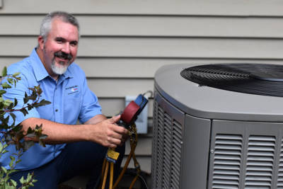 HVAC tech with air conditioner