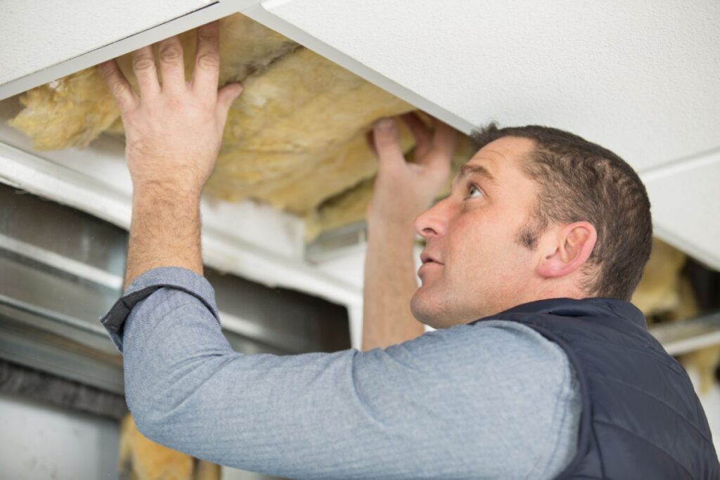 Professional installing new insulation in the ceiling