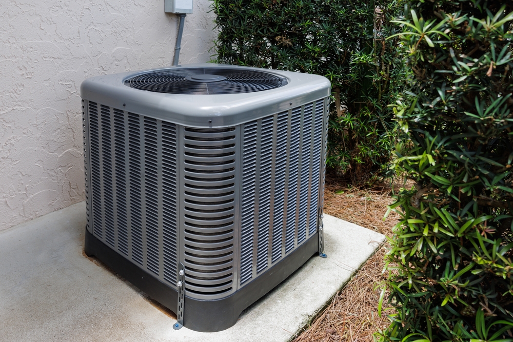 older air conditioner installed on a concrete slab that needs to be replaced