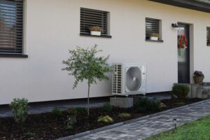 a heat pump system installed outside a home next to the back door