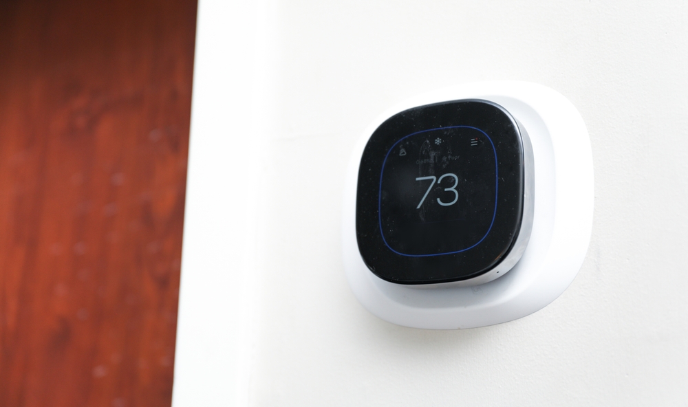 A smart thermostat set to 73 degrees in the winter