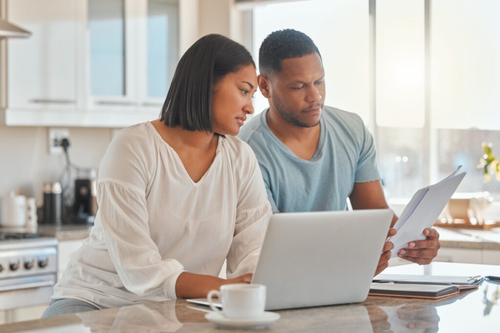 a husband and wife researching furnace sizes for their home