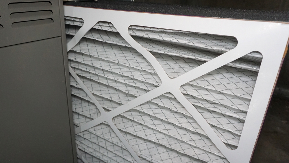 A new air filter being installed in a furnace