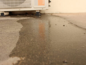 water flowing from an outdoor AC unit