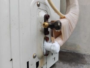 A frozen AC component due to a refrigerant leak