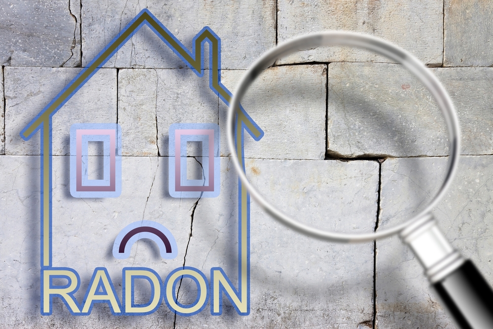 a digital rendering of a house with a sad face on top of a cracked concrete wall, where radon can get in
